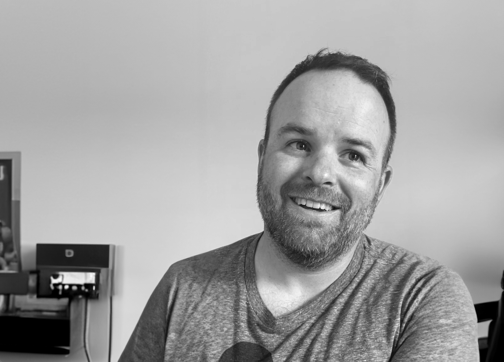 Jason smiling in front a white screen